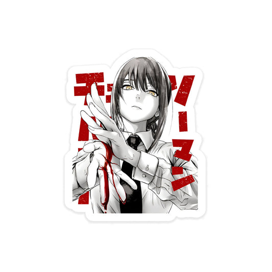 A rectangular sticker with a red background and a white horizontal stripe in the middle. In the center of the white stripe, black Devanagari text reads "घुमक्कड़" which translates to "Wanderer." The red background has faint travel-themed illustrations.