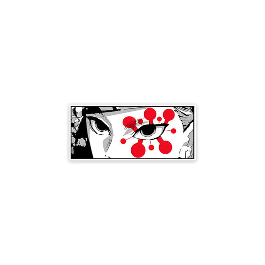 A rectangular sticker with a red background and a white horizontal stripe in the middle. In the center of the white stripe, black Devanagari text reads "घुमक्कड़" which translates to "Wanderer." The red background has faint travel-themed illustrations.